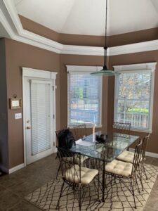 Dining room with brown paint and large windows
